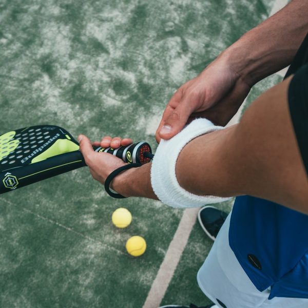 person-holding-black-and-green-tennis-racket-1103829.jpg